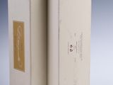 two white boxes with gold labels on them sitting side by side