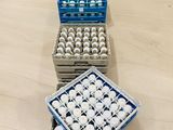 three crates of eggs are lined up on a wooden table