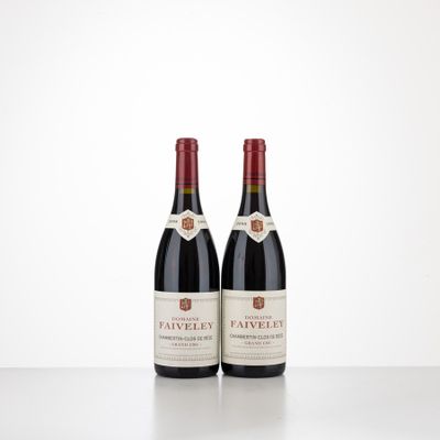 two bottles of wine sitting on top of a table