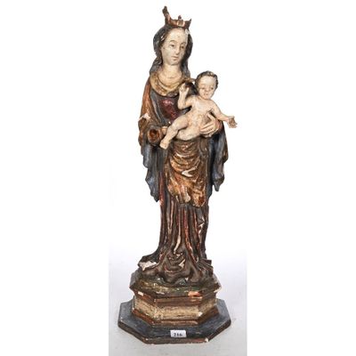 a statue of a woman holding a baby and wearing a crown