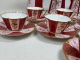 many cups and saucers that are sitting on a table