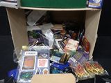 a cardboard box full of cards and games on the floor