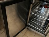 someone is opening the door of a stainless steel refrigerator in a kitchen