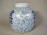 a blue and white vase with a bird on it