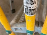 a close up of a yellow scaffolding with a barcode on it