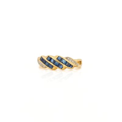 a yellow gold ring with blue sapphires and diamonds