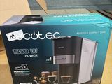 a box with a coffee maker inside of it on a table
