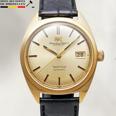 an image of a gold watch with a black leather strap