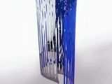 a blue and white vase with people standing in it