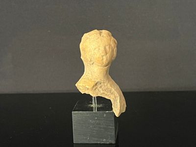a small statue of a woman on a black table