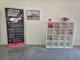 a display of a car in a garage next to a shelf