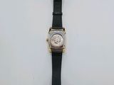 an image of a watch on a white surface with a tag attached to it