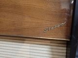 a close up of a wooden cabinet with a name on it