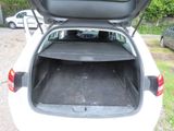 trunk of a white car with the top open and the back door open