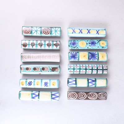 several pieces of ceramic art are displayed on a white surface