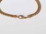 a gold chain bracelet with a clasp on a white background