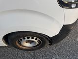 a close up of a white van with a flat tire
