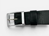 a black leather belt with a silver buckle on a white surface