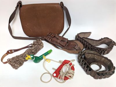 a brown purse and some other items on a white surface