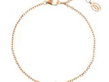 a gold bracelet with a white diamond on a chain