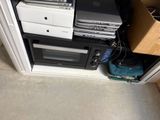 a stack of electronics sitting on top of a cabinet