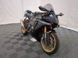 a picture of a black motorcycle parked on a checkered floor