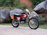 a red dirt bike parked on the side of the road