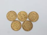 four gold sovereigns, one of which is a sovereign and the other of which is a sovereign