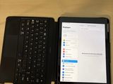 a tablet and a laptop sitting on a desk next to each other