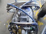 a motorcycle that is sitting on the ground with wires attached to it