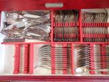 a red box with silverware in it on a table
