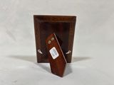 a small wooden picture frame with a tag on it