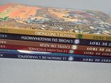 four books stacked on top of each other on a table