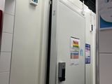 a refrigerator that is in the middle of a room
