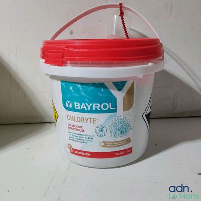 a plastic bucket with a red lid sitting on a counter