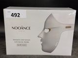 a box with a white mask on it on a table