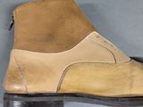 pair of brown and tan leather shoes on a gray surface