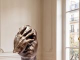 a sculpture on a table in a room with a window