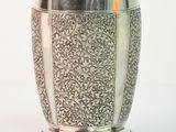 a silver cup that is sitting on a table