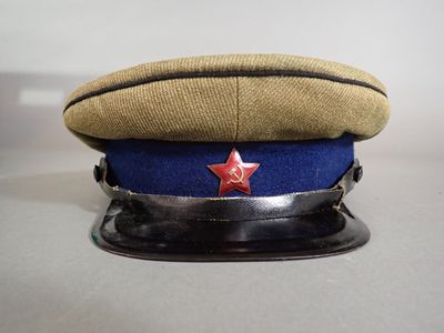 hat with red star on it sitting on top of a metal base