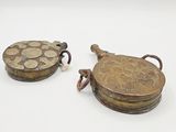 pair of antique brass plated objects on a white surface