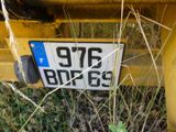 a license plate on the back of a yellow truck