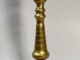 pair of brass candlesticks on a white background