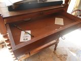 a suitcase sitting on top of a table with a pen in it