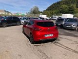 a red car that is parked in a parking lot