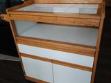 a white and wood cabinet with drawers in the room