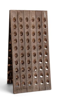 a wooden wine rack that has holes in it