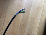a close up of a pair of wires on a wooden floor