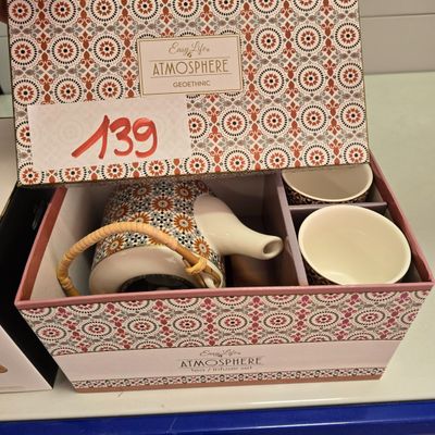 a box with a tea set inside of it
