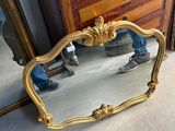 a mirror that is sitting on the floor in front of a dresser